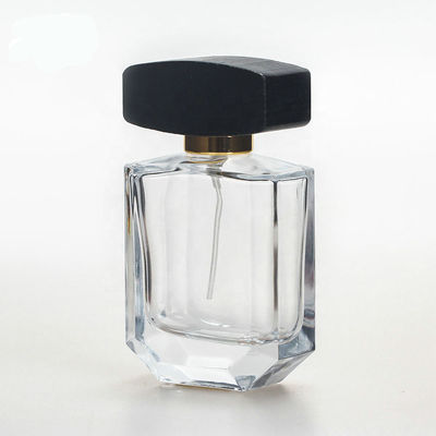 Empty glass perfume bottle with cap and pump spray collarwith wooden black cap